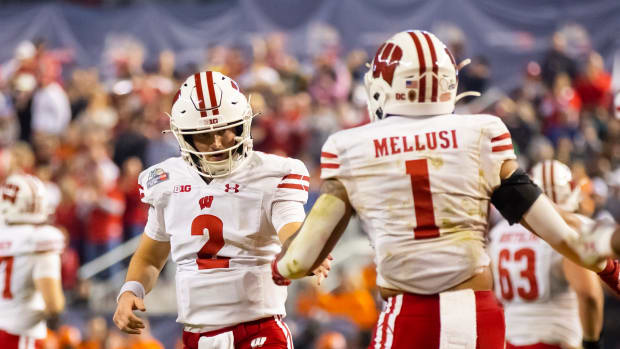 Chase Wolf and Chez Mellusi celebrate a touchdown in the Guaranteed Rate Bowl.